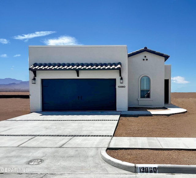 view of front of house featuring a mountain view and a garage