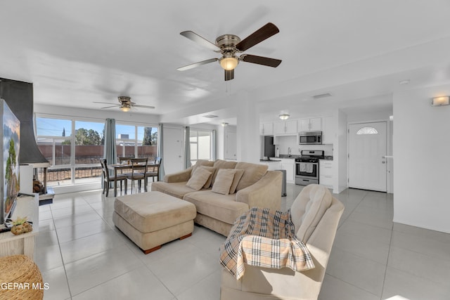 living room with ceiling fan and light tile patterned floors