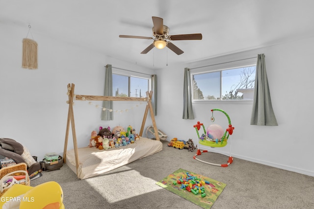 playroom featuring carpet, ceiling fan, and a wealth of natural light