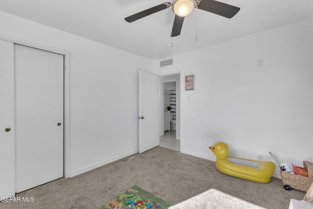 game room with ceiling fan and light colored carpet