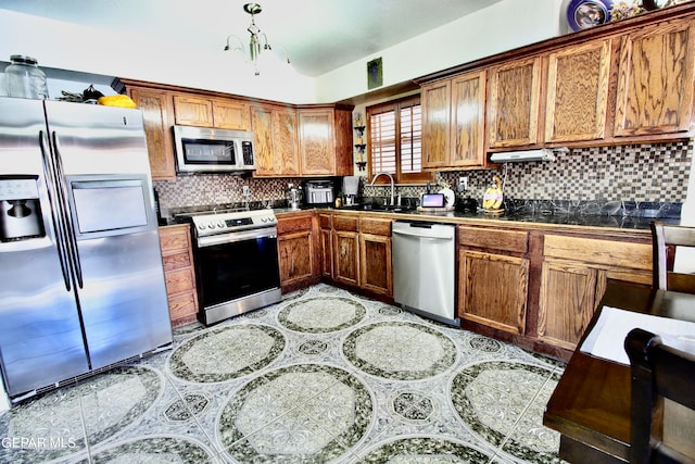 kitchen featuring stainless steel appliances, tasteful backsplash, and sink