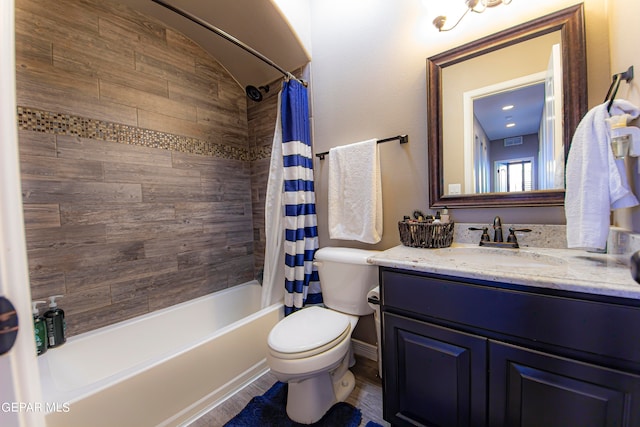 full bathroom with vanity, shower / bath combo with shower curtain, and toilet