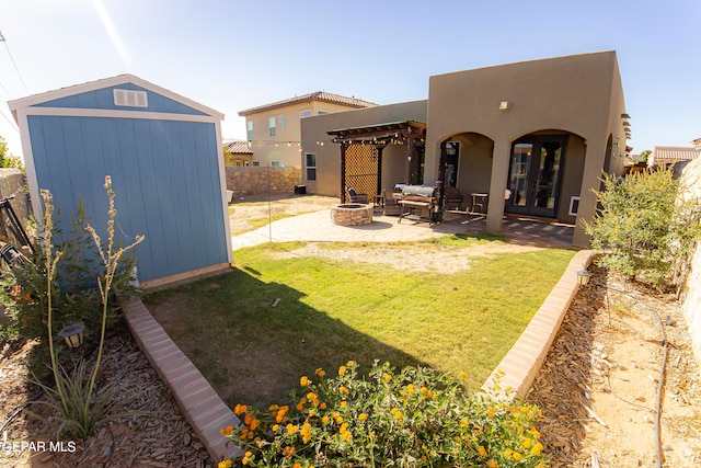 view of yard with outdoor lounge area, a storage unit, a pergola, and a patio area