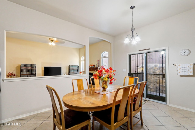 tiled dining space featuring a chandelier