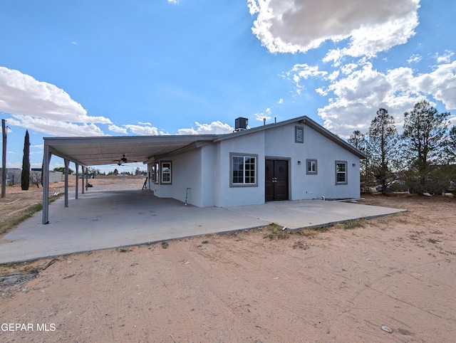 back of property with a carport