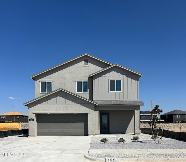 12832 Star Gaze Ave, El Paso, TX 79928 - view of front of house featuring board and batten siding, concrete driveway, and an attached garage