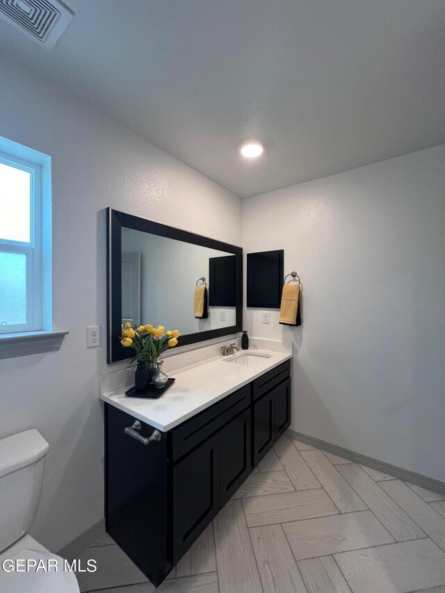 bathroom featuring vanity and toilet