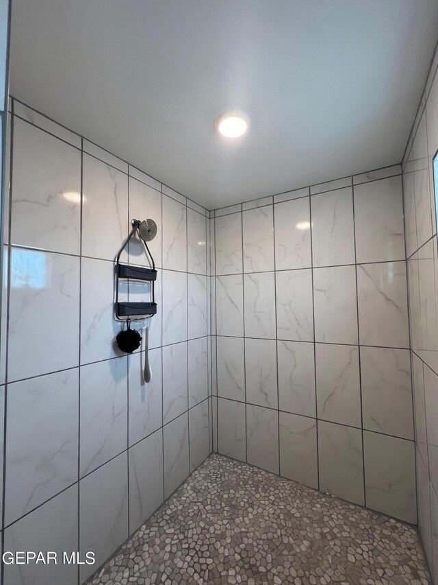 bathroom with tiled shower