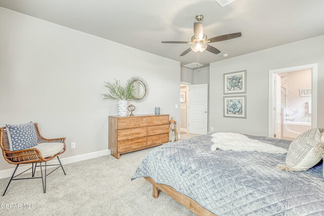 bedroom with connected bathroom, light colored carpet, and ceiling fan