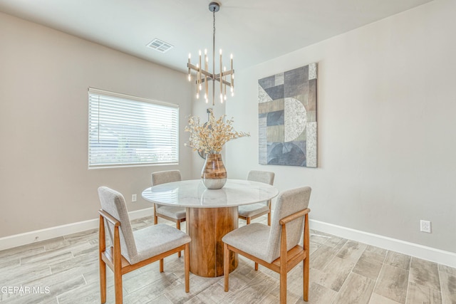 dining area featuring a notable chandelier and light hardwood / wood-style flooring