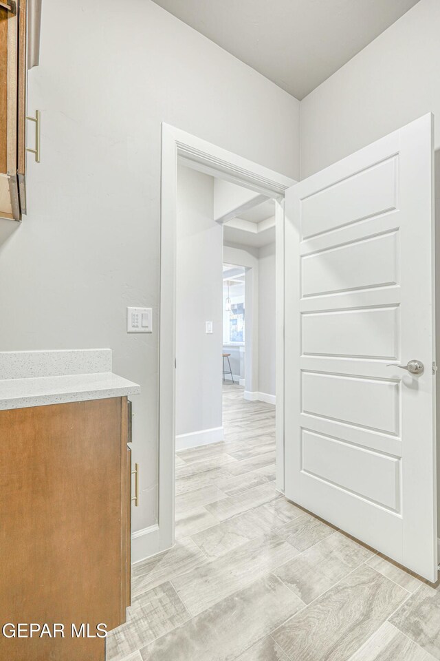 hallway with light wood-type flooring