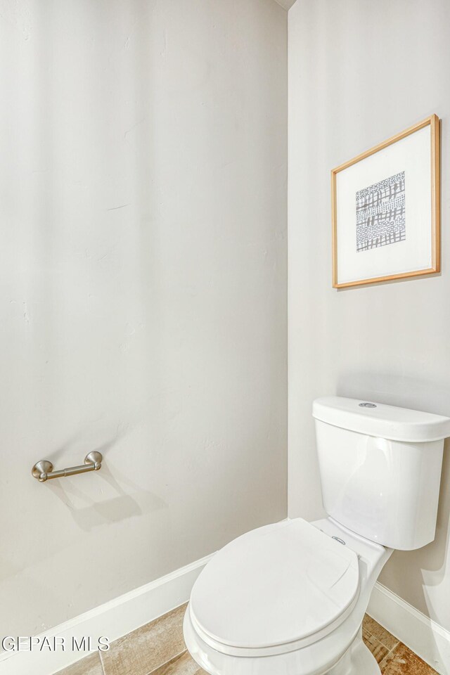 bathroom with tile patterned flooring and toilet