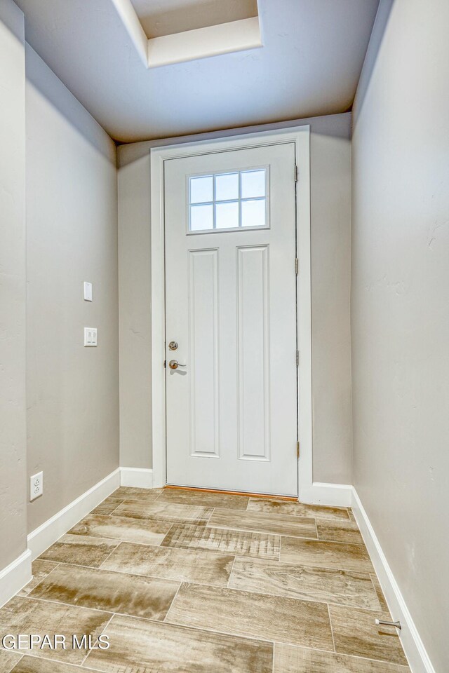 entryway with hardwood / wood-style flooring