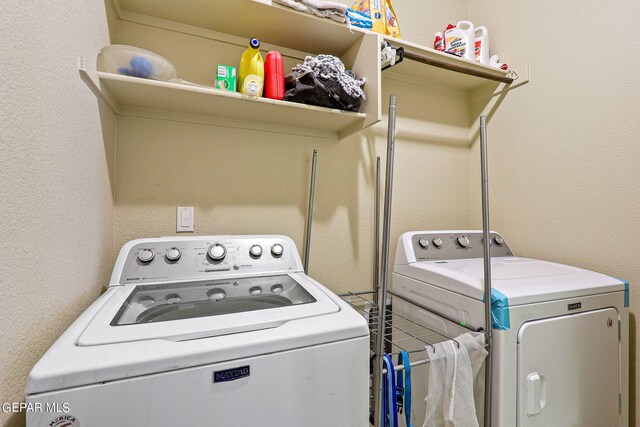 clothes washing area with washer and dryer