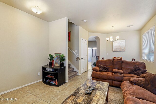 living room with light tile patterned floors and a chandelier