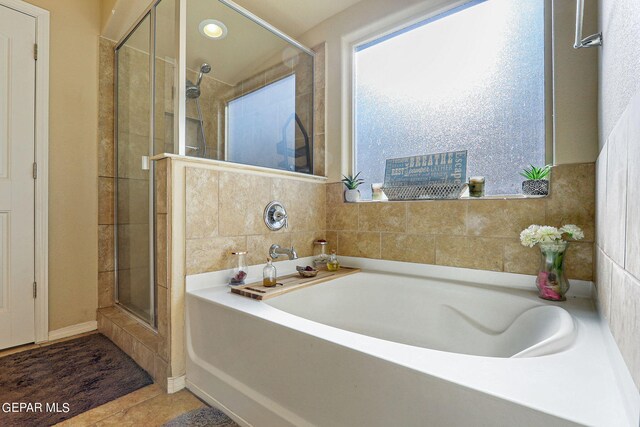 bathroom featuring tile patterned flooring and independent shower and bath