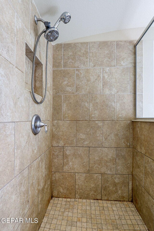 bathroom with tiled shower