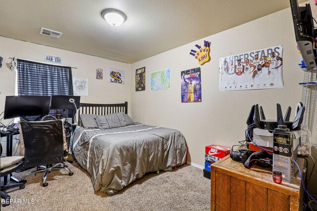 carpeted bedroom featuring a textured ceiling