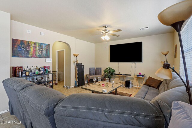 tiled living room featuring ceiling fan