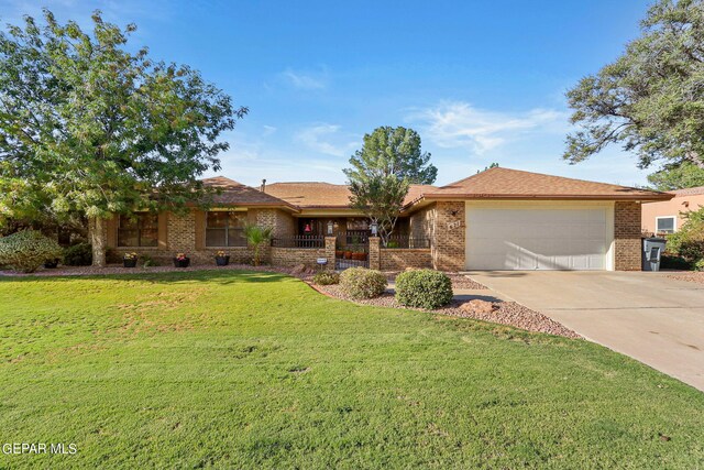 single story home featuring a garage and a front lawn