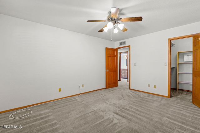 unfurnished room featuring light carpet and ceiling fan