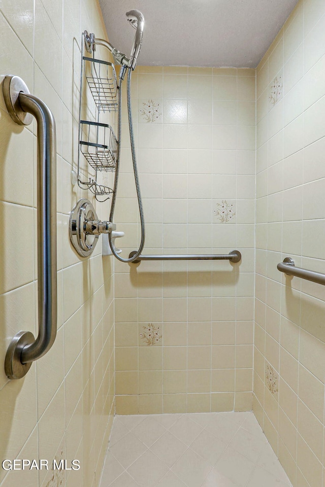 bathroom with a tile shower