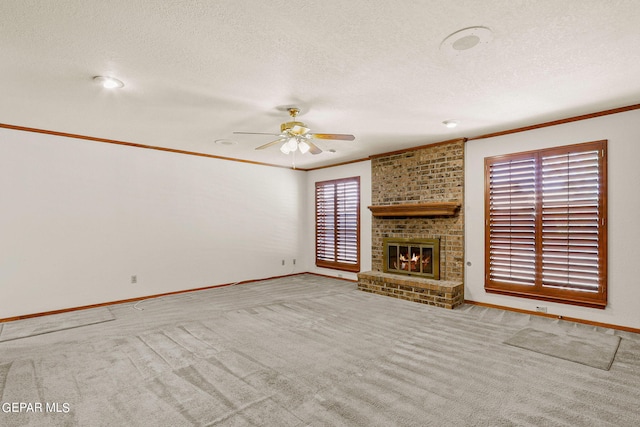 unfurnished living room featuring a textured ceiling, a fireplace, ceiling fan, and light colored carpet