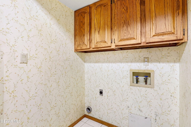 washroom featuring washer hookup, cabinets, light tile patterned flooring, and electric dryer hookup