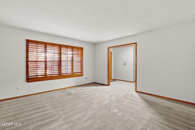 carpeted empty room with a textured ceiling