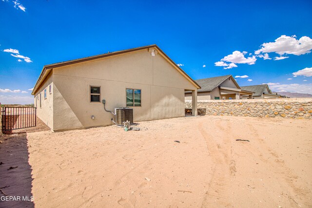 back of property featuring central AC unit