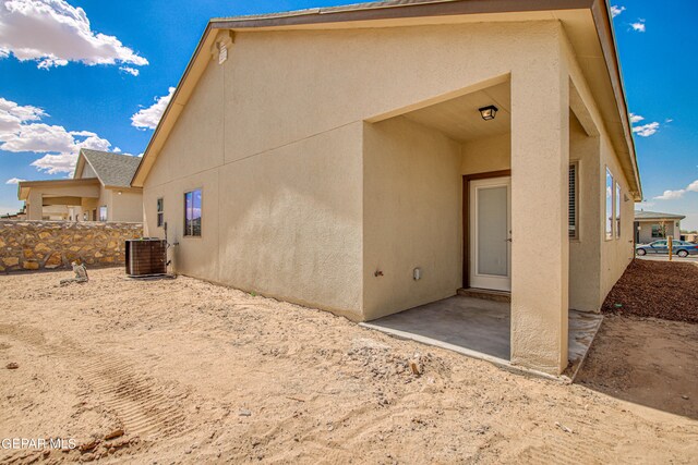 rear view of property featuring a patio and central air condition unit