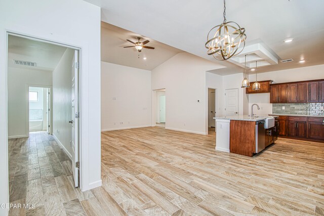 kitchen with an island with sink, hanging light fixtures, light hardwood / wood-style flooring, dishwasher, and ceiling fan with notable chandelier