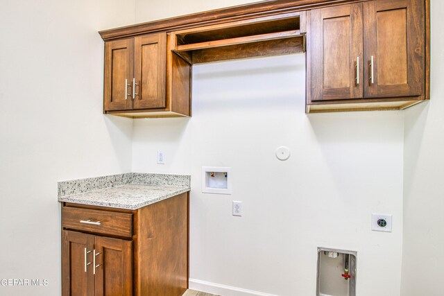 clothes washing area with hookup for a gas dryer, hookup for an electric dryer, washer hookup, and cabinets