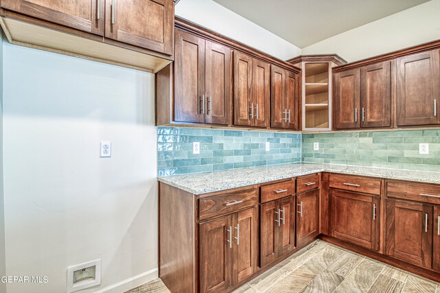 kitchen with light stone counters and decorative backsplash