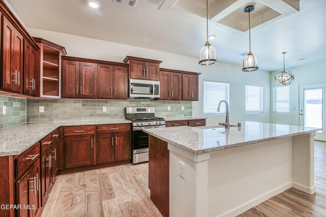 kitchen featuring light hardwood / wood-style flooring, decorative backsplash, appliances with stainless steel finishes, and plenty of natural light