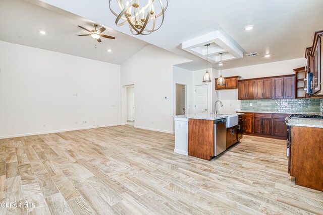 kitchen featuring decorative light fixtures, a kitchen island with sink, ceiling fan with notable chandelier, and light hardwood / wood-style flooring