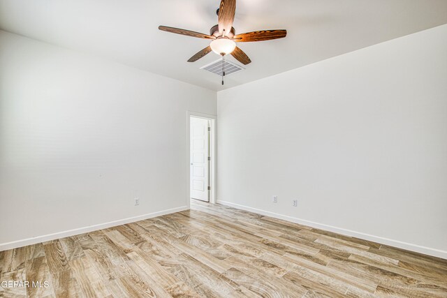 empty room featuring ceiling fan and light hardwood / wood-style floors