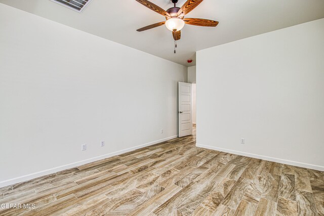 spare room featuring light wood-type flooring and ceiling fan