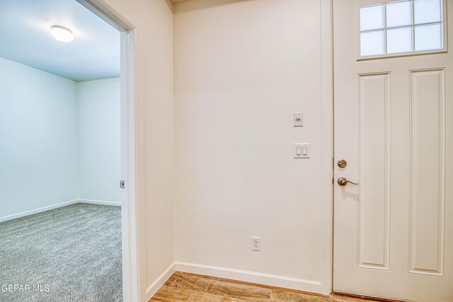 foyer featuring light colored carpet