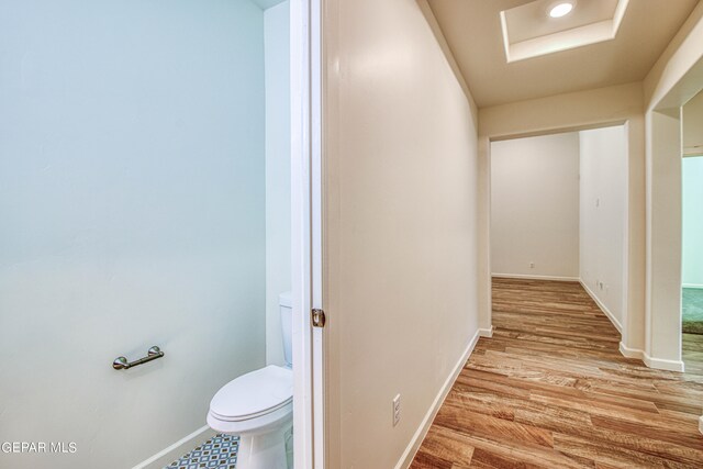 interior space with wood-type flooring and toilet