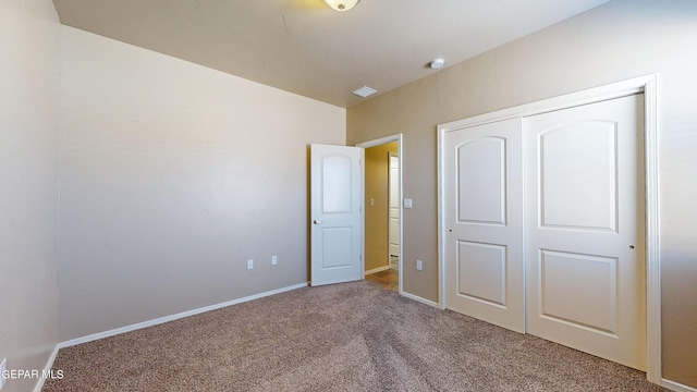 unfurnished bedroom with carpet flooring and a closet