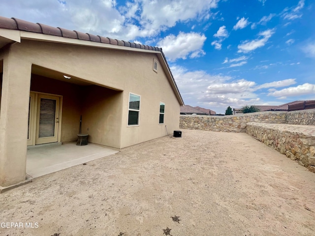 view of side of home featuring a patio