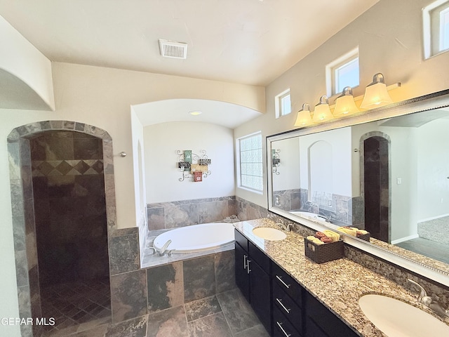 bathroom featuring vanity and plus walk in shower