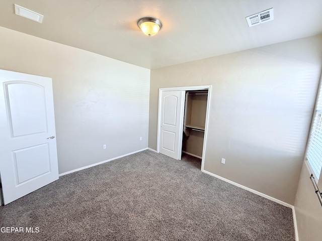 unfurnished bedroom with carpet floors and a closet