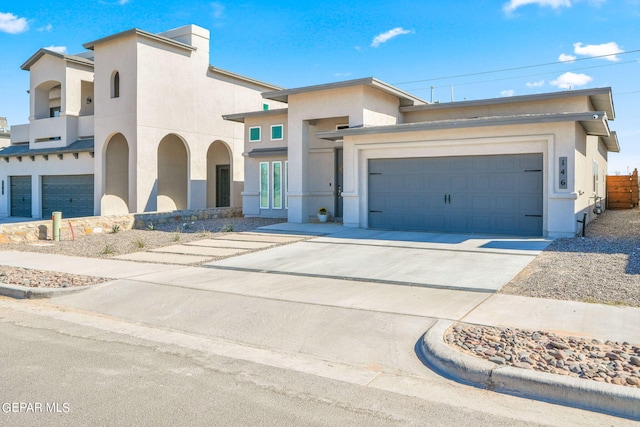 view of front of property with a garage and a balcony