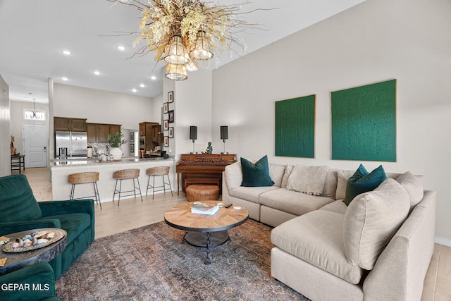 living room featuring an inviting chandelier and light wood-type flooring