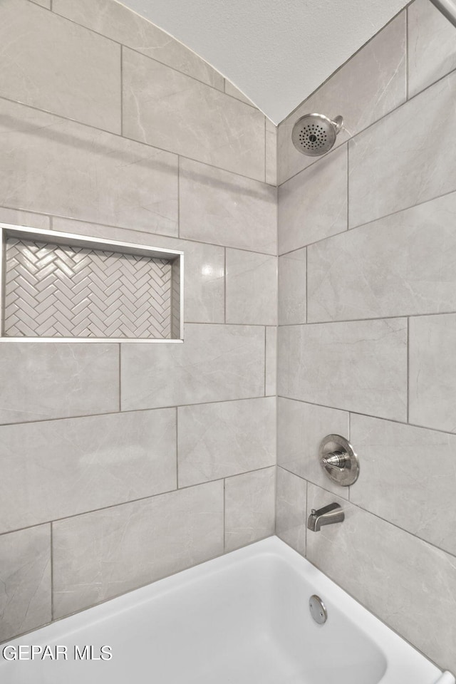 bathroom featuring tiled shower / bath