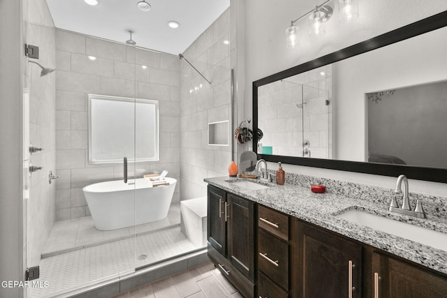 bathroom with vanity, plus walk in shower, and tile walls