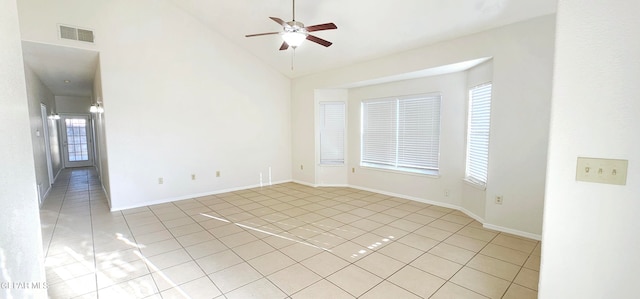 tiled spare room featuring high vaulted ceiling and ceiling fan