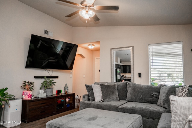 living room featuring ceiling fan, hardwood / wood-style flooring, and lofted ceiling